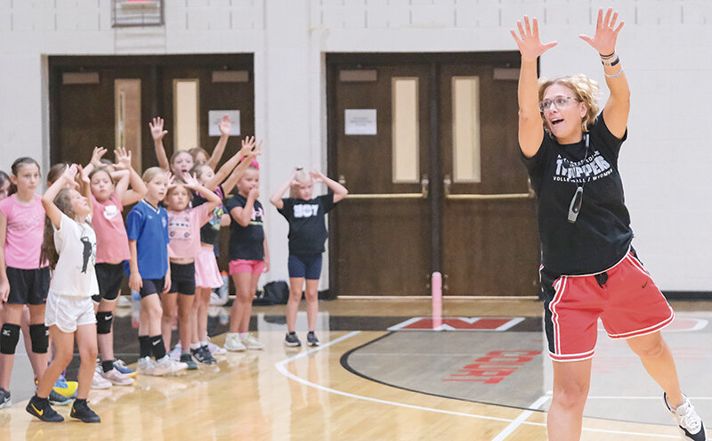 New Northwest College volleyball coach Nicole Buck (right) Supermans in front of campers to demonstrate the follow-through for setting a ball during the Trapper youth camp in July.
Tribune photo by Seth Romsa