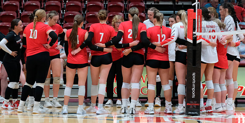 Former and current Trappers gather at midcourt in between sets to determine who will play with the alumni in the next set as the teams combined for a scrimmage on Friday.
Tribune photo by Seth Romsa
