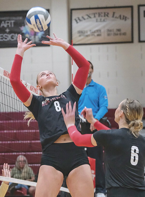 Aidann Mottishaw (left) sets the ball for Ellianna Baumstarck during a home match in early September. Mottishaw led the Trappers in assists in the first two Region IX contests.