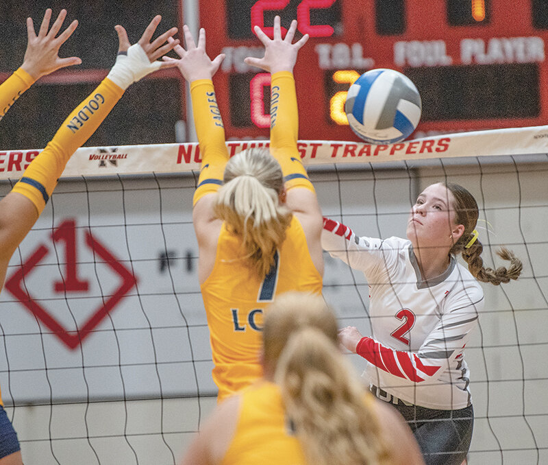 Lexie Arnold watches her shot get just over the net against the LCCC block on Friday night. Northwest fell to the visiting Golden Eagles 3-1.