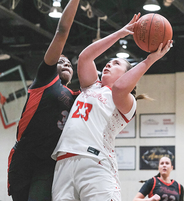 McKinlee Covolo (right) puts up a shot at the basket against Casper College. Covolo led the Trappers with 21 points in a win on the road Saturday in Riverton.