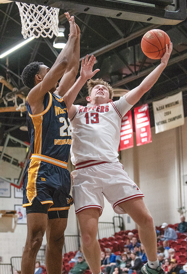 Trey Rinn (right) finished with 12 points for the Trappers in their play-in win on Saturday as the men pushed past visiting Western Nebraska CC 85-73.