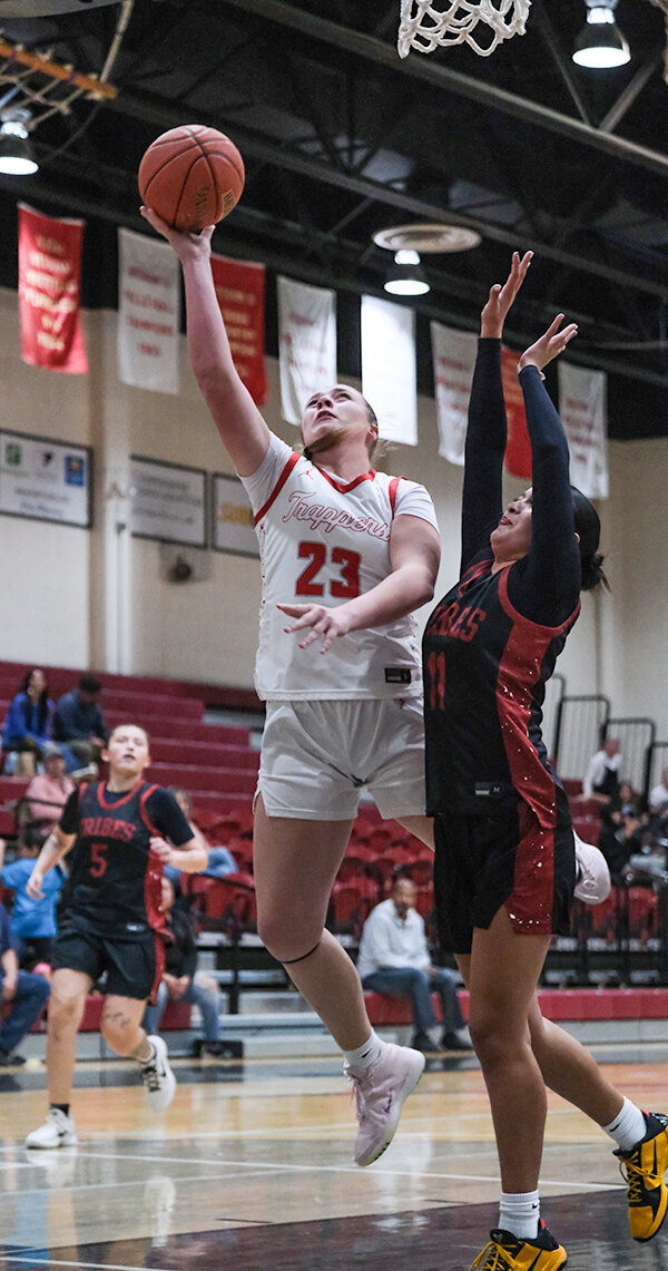 McKinlee Covolo (left) puts up a shot at the basket during a November game. Helenbolt and the Trappers are hoping for a healthier second semester after Covolo missed the final five games before the winter break.